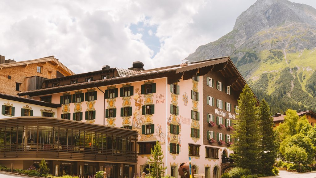 Directions | Getting to Hotel Post Lech Arlberg | Arrival & Travel Information Traditional inn with painted walls and mountains in the background