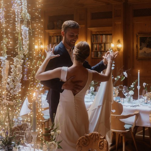 Events in Lech | Hotel Post Lech Arlberg Bride and groom dancing in a decorated room with string lights and flowers