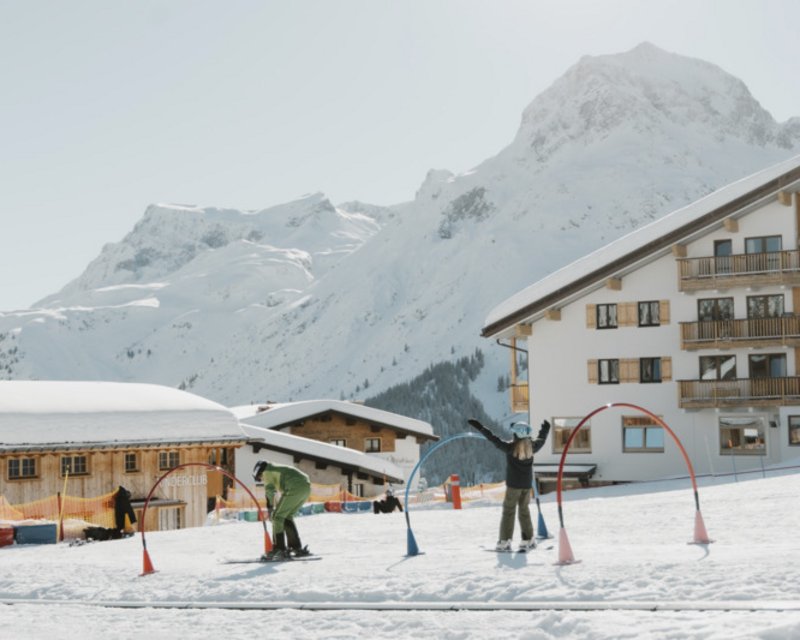 Neues aus der Post Skifahrer fährt auf schneebedeckter Piste in den Alpen bei klarem Himmel