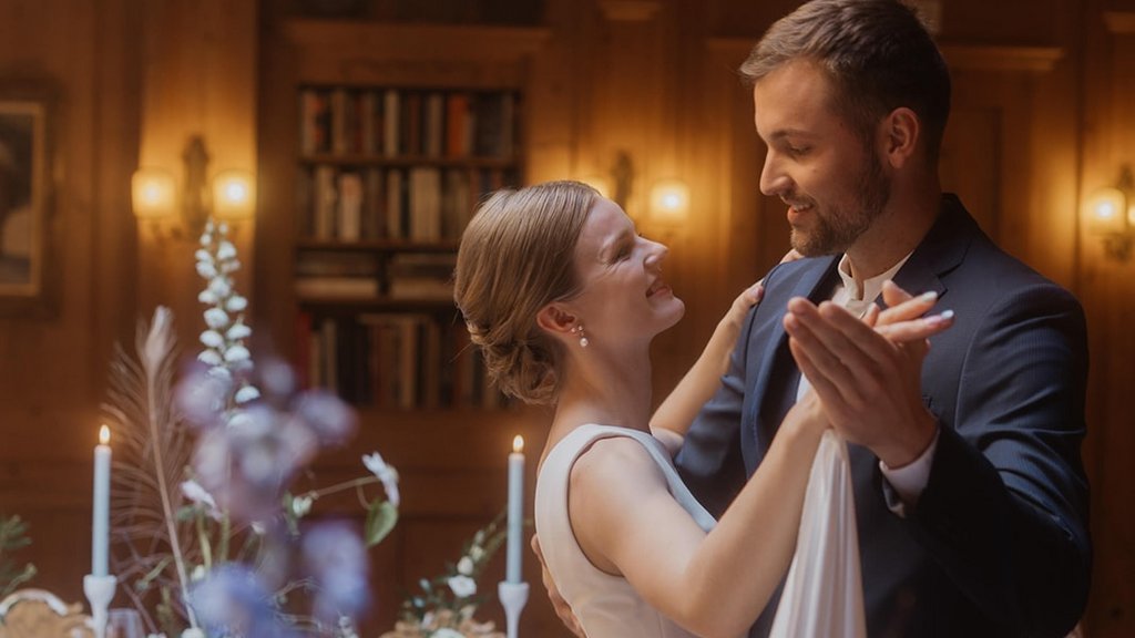 Events in Lech | Hotel Post Lech Arlberg Bride and groom happily dancing at a wedding in a decorated hall